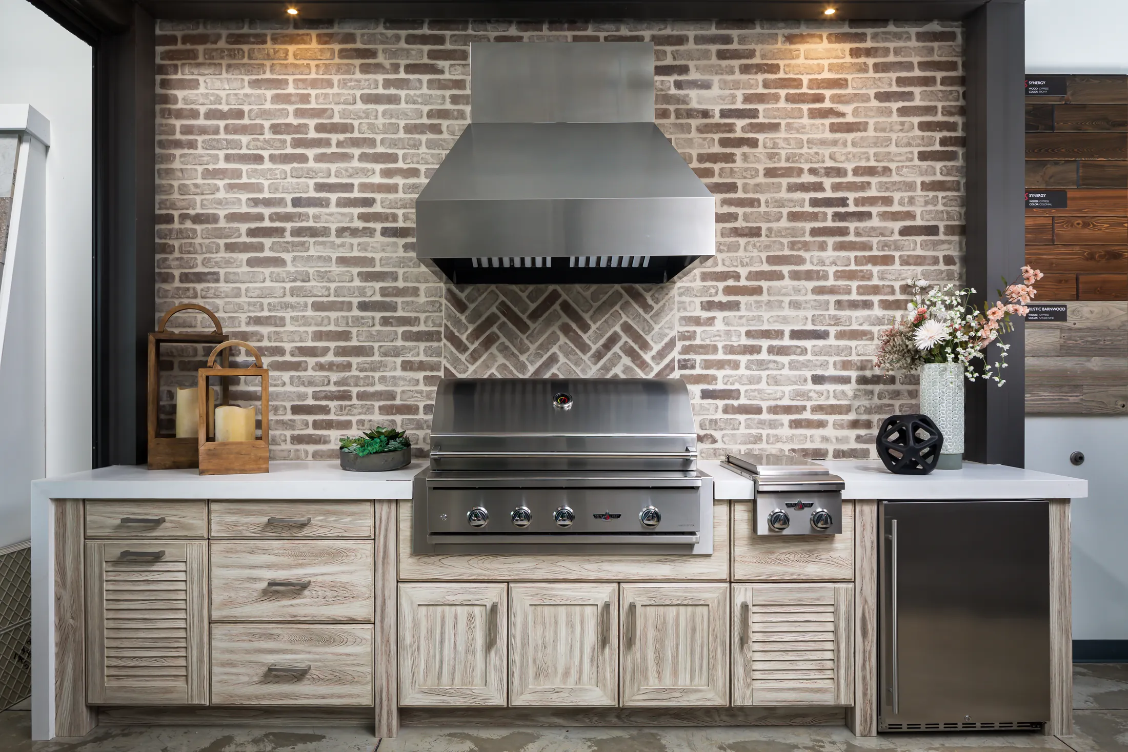 Custom outdoor kitchen with grill, hood and cabinetry by Knäak Design Group, Naples Florida